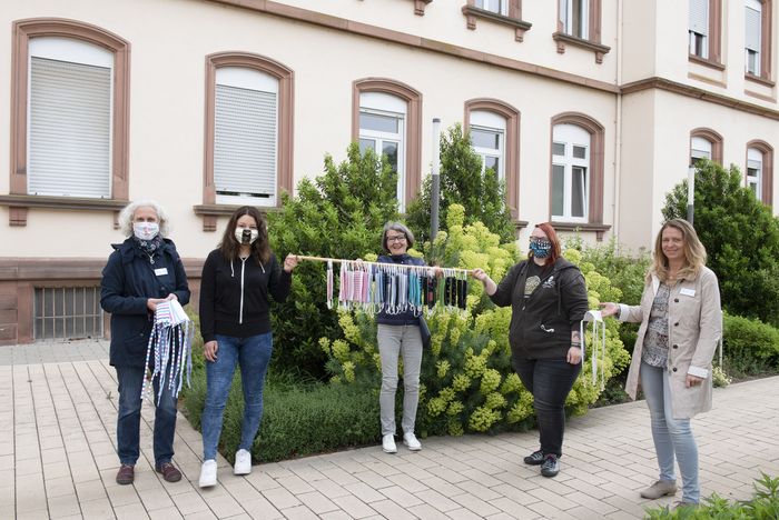 spenderin übergibt selbstgenähte Masken vorm Mutterhaus